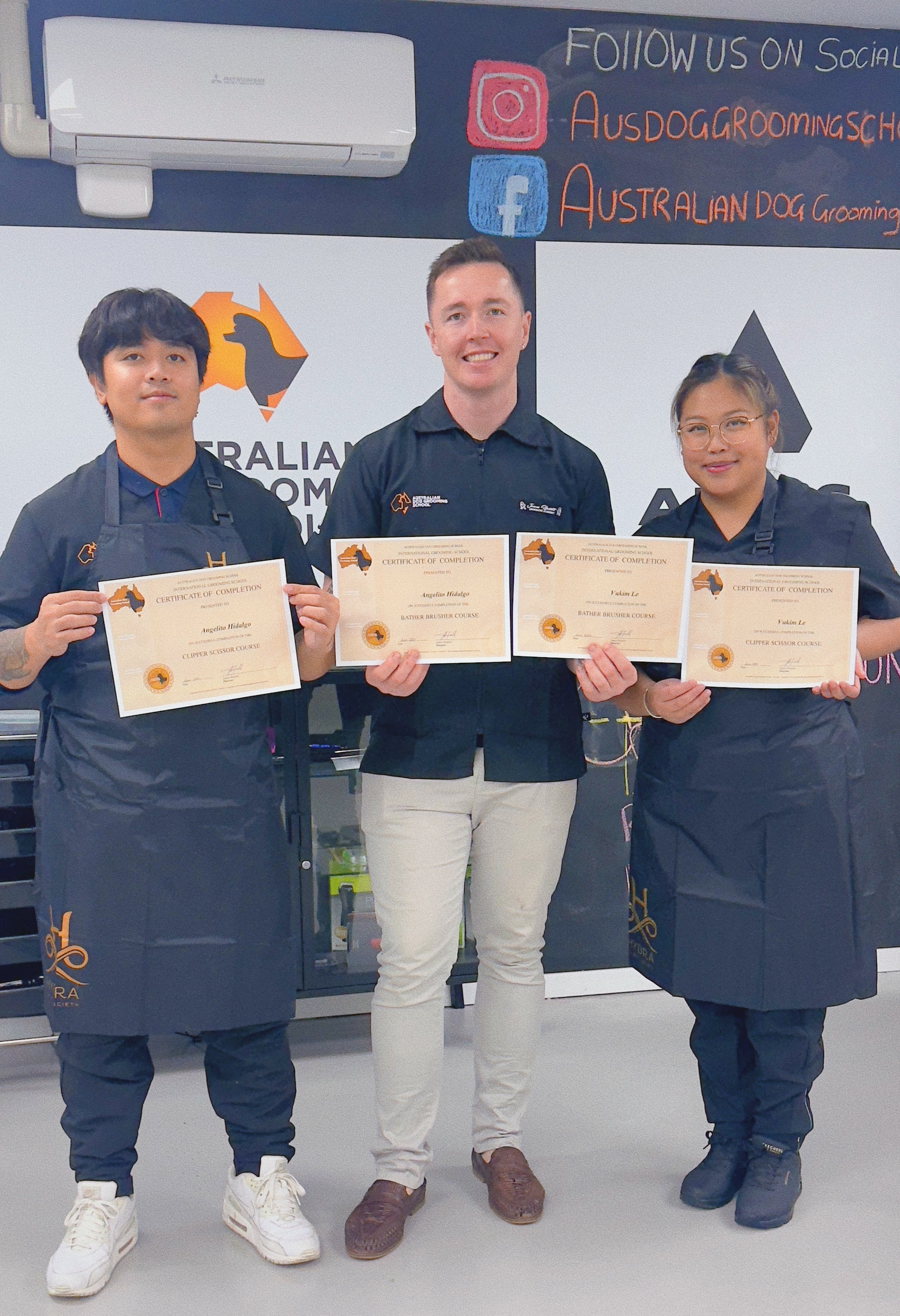 Angelito and Kim receiving their certificates from the Australian Dog Grooming School